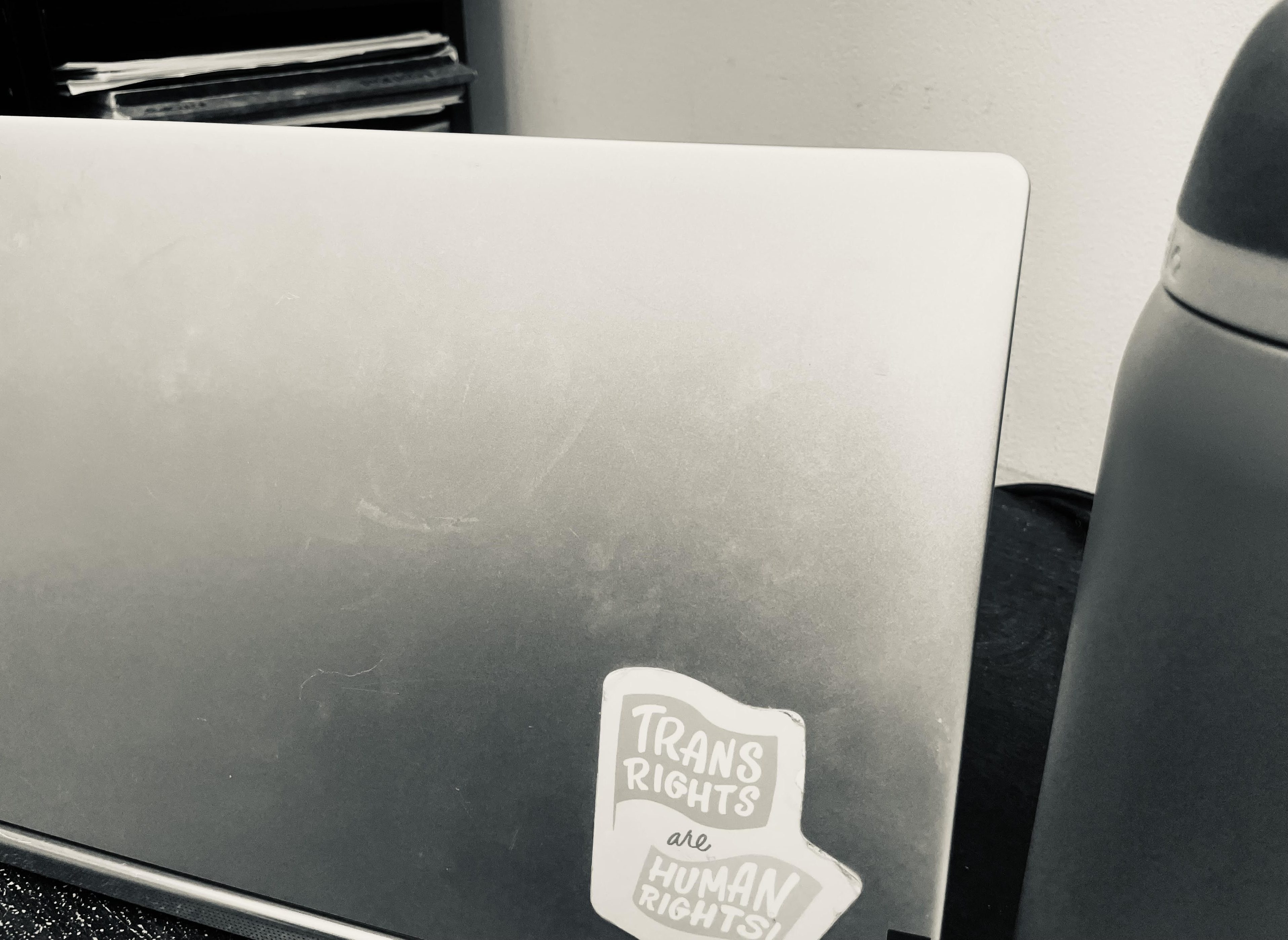 picture of open laptop at a desk next to a water bottle